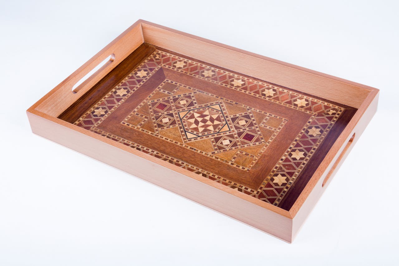 services-03 Elegant handcrafted wooden tray featuring detailed inlaid patterns. Perfect for decor or serving.